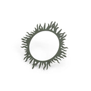 Dark green spirulina tuile ring with wavy, flame-like organic shapes on a white background.