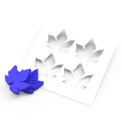 Blue silicone vine leaf molds next to a white stencil with matching leaf-shaped cutouts.