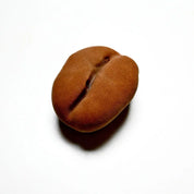 Realistic brown chocolate coffee bean molded with a textured matte finish on a white background.